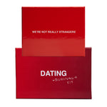 Red box bundle with inner card reading "We're Not Really Strangers" and outer box labeled "Dating Survival Kit."
