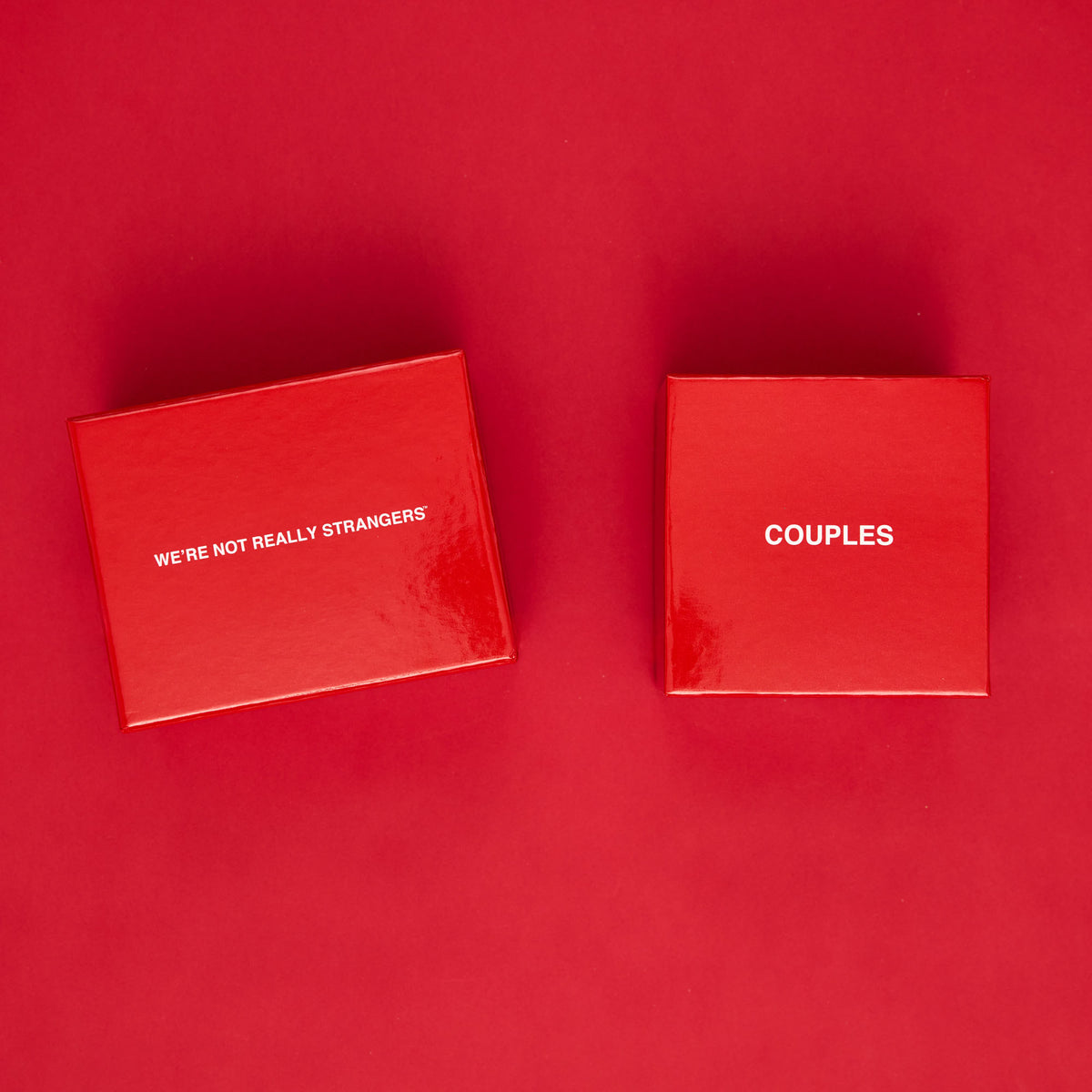 Two red boxes on red background, left labeled "We're Not Really Strangers" and right labeled "Couples".