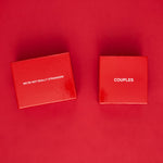 Two red boxes on red background, left labeled "We're Not Really Strangers" and right labeled "Couples".