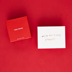 Red box labeled "Family Edition" and white card with handwritten text on red background.