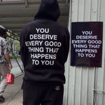 Black hoodie and sweatpants set with white text reading "You deserve every good thing that happens to you" on back.