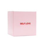 Pink box with "SELF LOVE" printed in red text on the front cover.