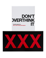 A white "Don't Overthink It" party game box sits behind a wide black box printed with three large red X letters.