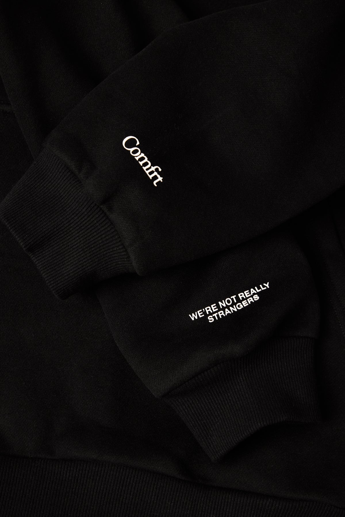 Black sweatshirt and sweatpants set with white "Comfrt" logo on chest and text on leg.