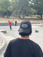 Black dad hat with white text reading "IDK WHAT'S GOING ON BUT IT'S A LOT" on the front.