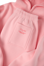 Pink sweatpants with elastic waistband and back pocket featuring embroidered Comfrt branding.