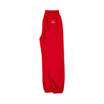 Red sweatpants with elastic waistband, side pockets, and small chest logo.