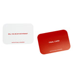 Two rounded rectangular cards displayed: light gray card with red text reading "WILL YOU BE MY BOYFRIEND?" and "WE'RE NOT REA