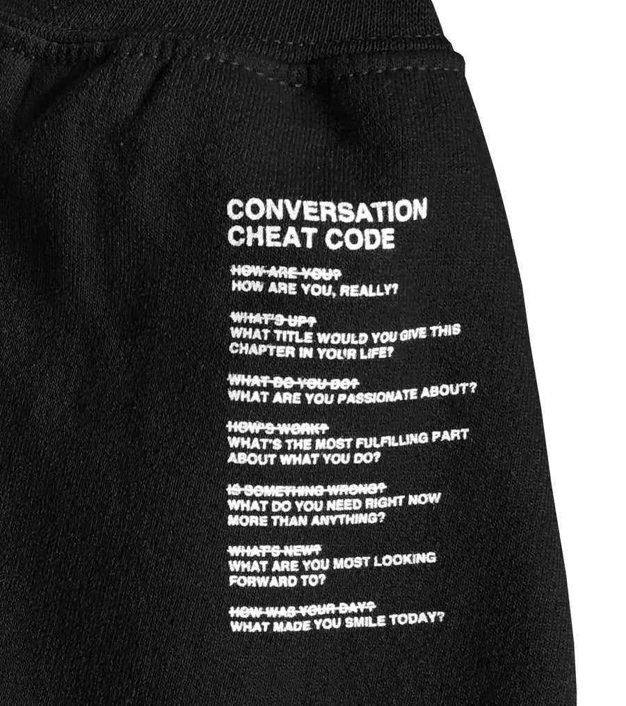 We're Not Really Strangers Black Cheat Code Crewneck laying flat zoomed in show sleeve detail