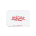 White rounded card with red text displaying game instructions about writing messages to other players and the game title.