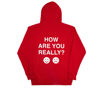 We're Not Really Strangers Mental Health Awareness Month. Back view of Red How Are You Really Hoodie with large white text reading "How Are You Really?" with an emoji smiley face and emoji frown face in white below the text.