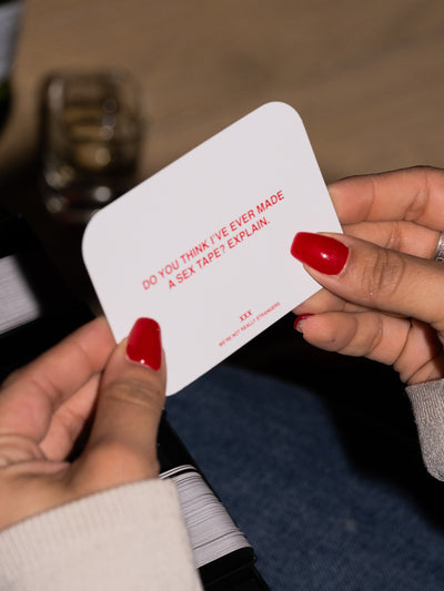 We're Not Really Strangers Sex Edition.  Person holding card reading "Do you think I've ever made a sex tape? Explain."