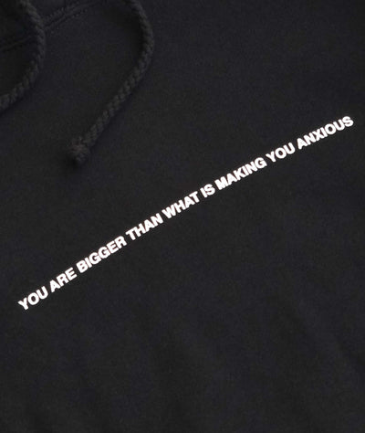 We're Not Really Strangers close up view of black hoodie saying You are bigger than what is making you anxious
