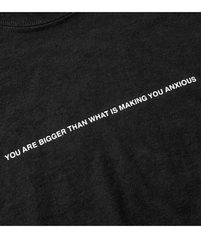 We're Not Really Strangers close up view of black t-shirt You are bigger than what is making you anxious